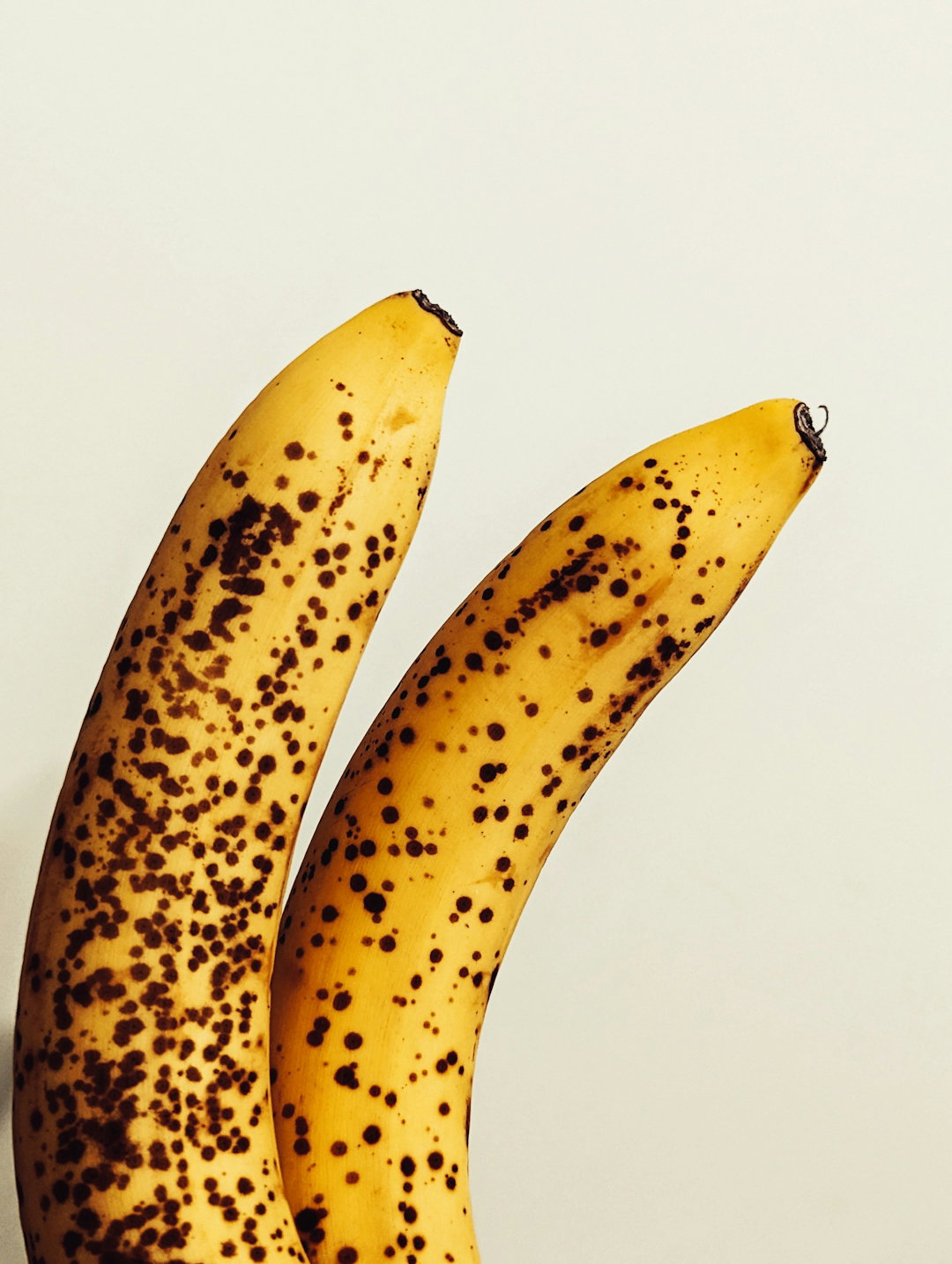 Two ripe bananas with brown spots